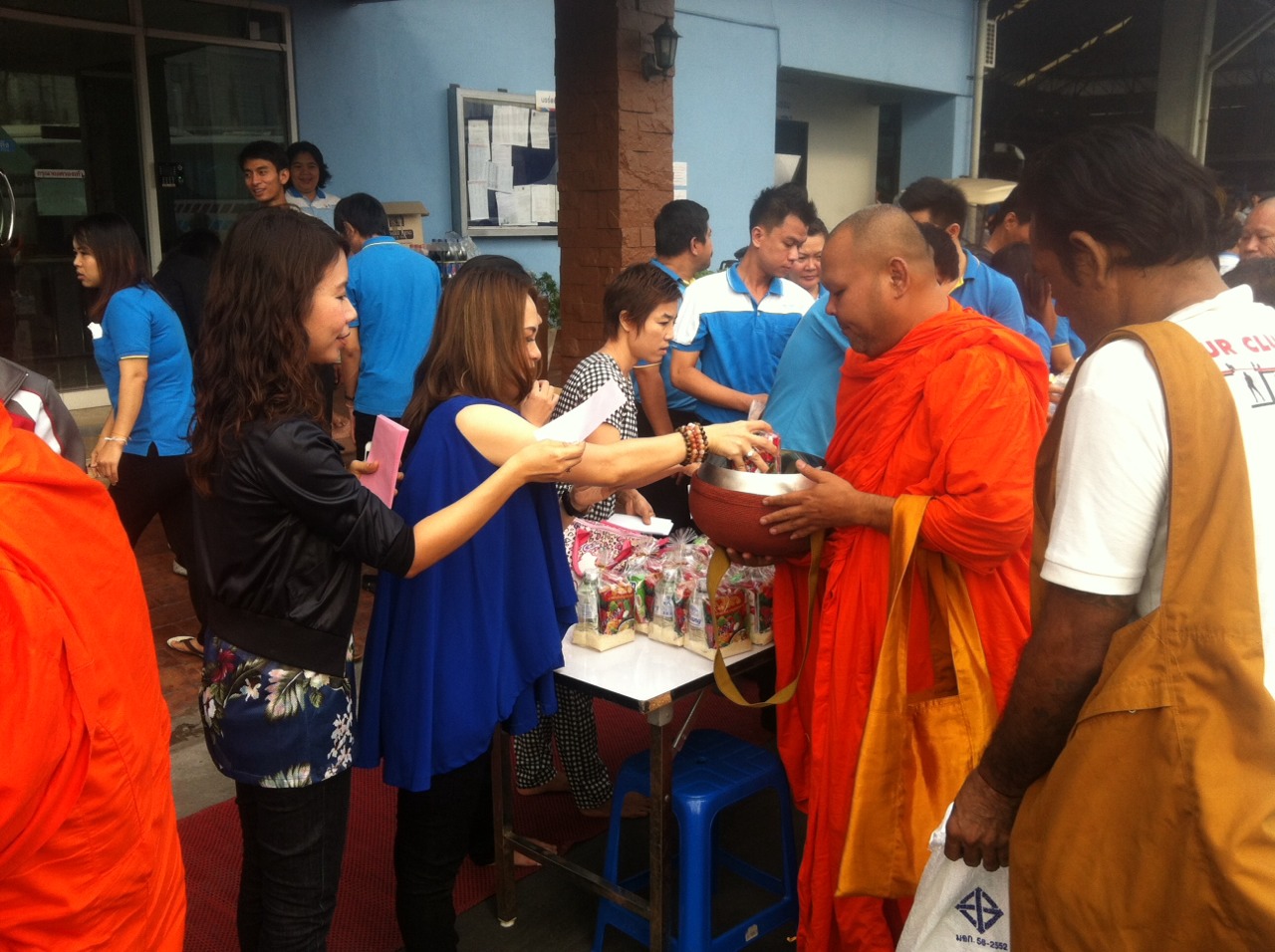 Executives gave alms to the monks on the occasion of new year 2015